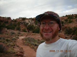 Canyonlands -- Lathrop Trail -- Adam hiking uphill