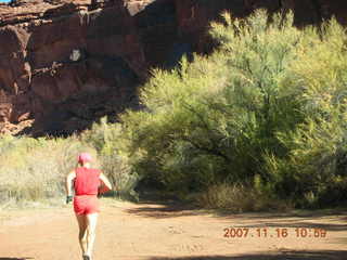 179 6bg. Canyonlands National Park - Lathrop Trail hike - Adam (tripod) running
