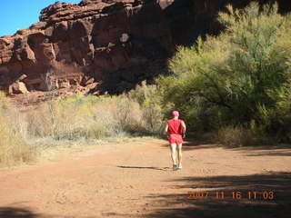 185 6bg. Canyonlands National Park - Lathrop Trail hike - Adam (tripod) running