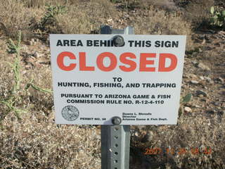 'Area behind this sign CLOSED to hunting, fishing, and trapping' sign.