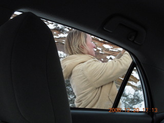 131 6ql. Zion National Park - Debbie taking a picture seen from inside the car