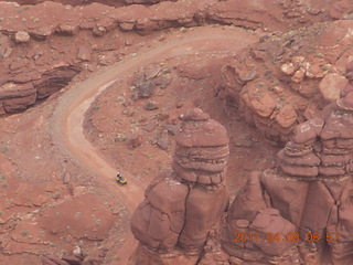 59 7j8. Anticline Overlook - someone driving on dirt road below