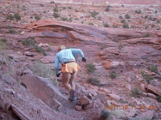 35 7qb. Canyonlands National Park - Lathrop trail hike - Adam hiking - back (tripod)