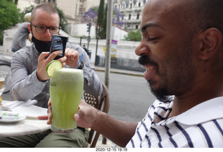 55 a0y. Argentina - Buenos Aires - lunch at Pertulli restaurant - Paul taking picture of Shane's drink