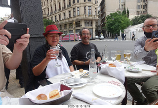 56 a0y. Argentina - Buenos Aires - lunch at Pertulli restaurant - Leticia, Chris, Paul taking pictures of Shane's drink