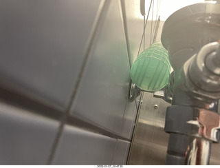 bathroom - water holder behind urinal pipes