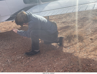 141 a20. Dirty Devil airstrip - digging dirt to turn airplane around