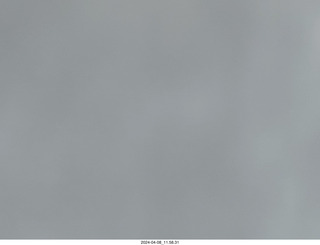 67 a24. Torreon eclipse day - partial eclipse through clouds, attempt by iPhone